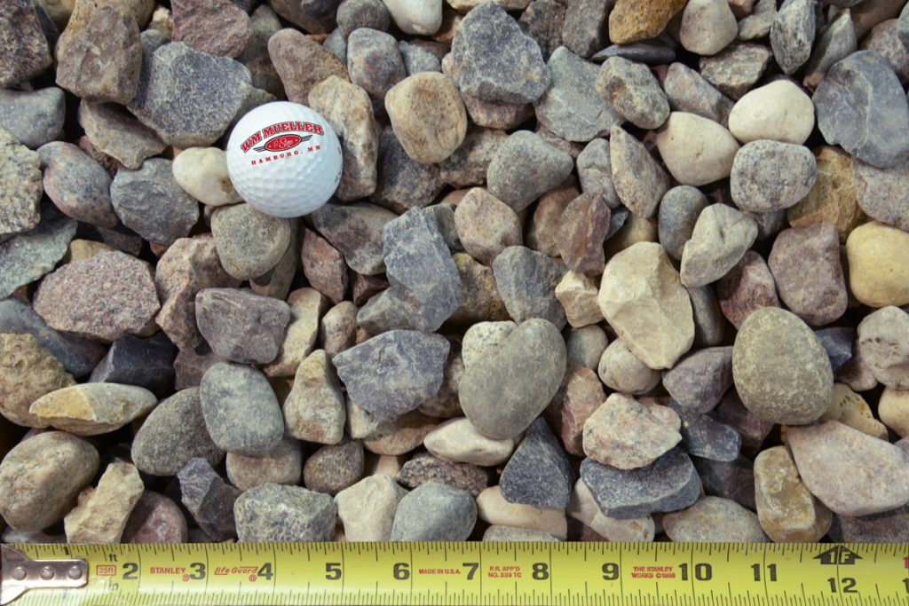 Binder rock with golf ball and measuring tape for size